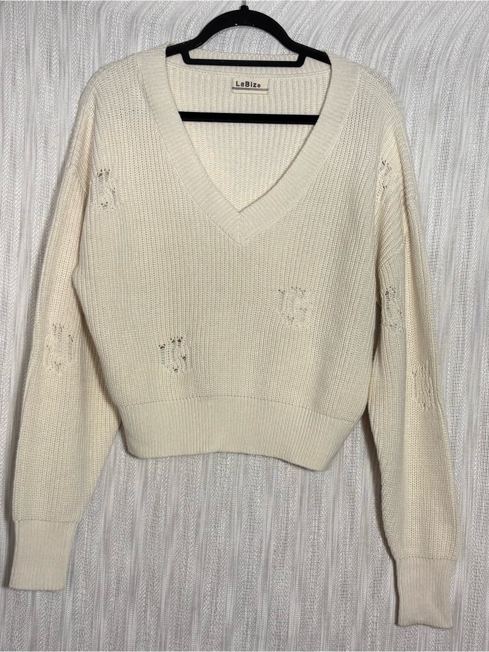 LaBiz V-neck sweater featuring unique distressed ladder detailing